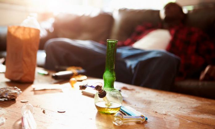 http://www.shutterstock.com/pic-193975568/stock-photo-man-slumped-on-sofa-with-drug-paraphernalia-in-foreground.html?src=4lTlzDiUlhpOsAbP4X6h_A-1-6