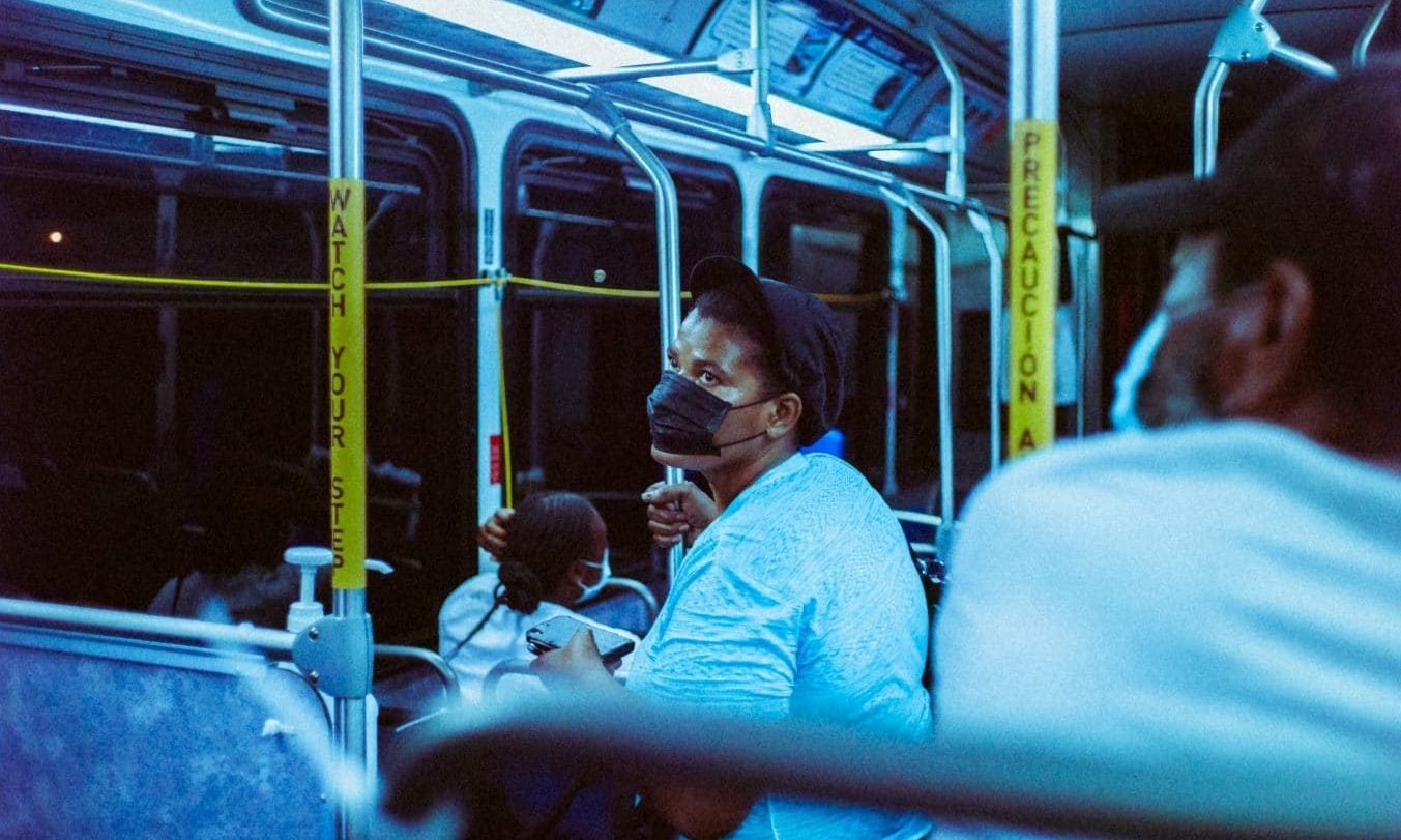woman in blue sweater sitting on bus seat
