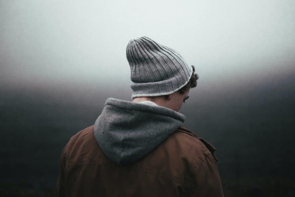 Man in knitted hat on gray background