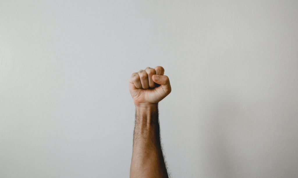 persons right arm on white wall