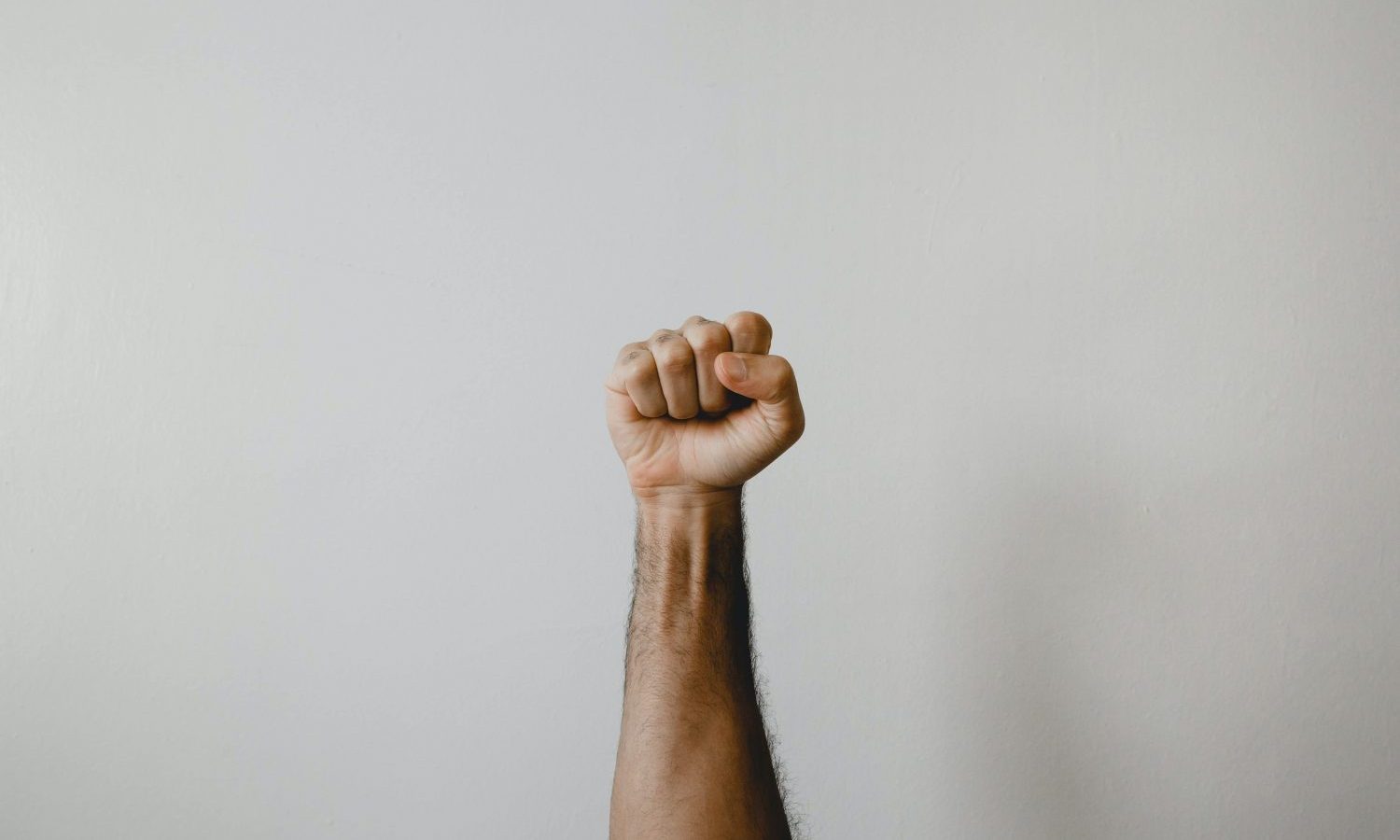 persons right arm on white wall