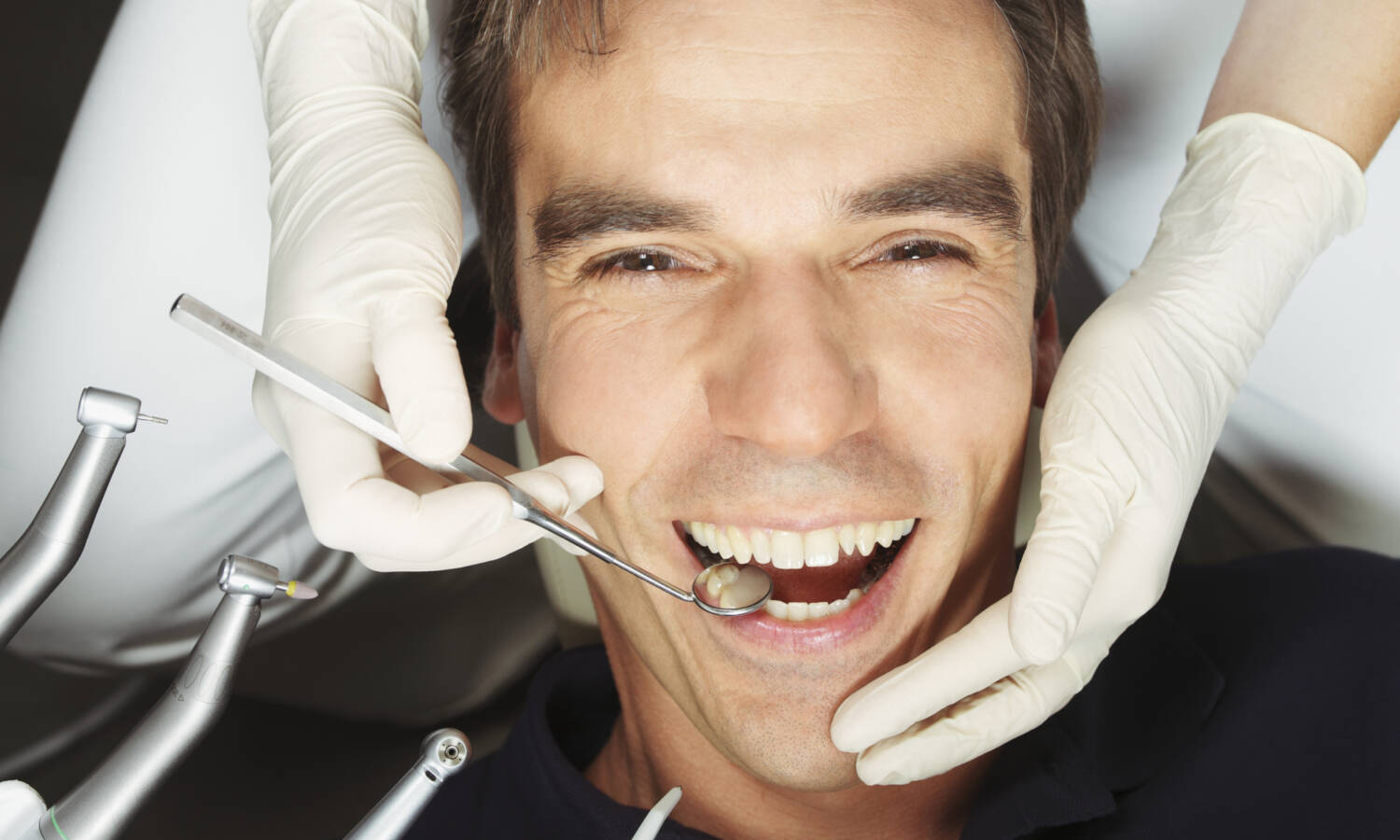 man sitting in dentist chair