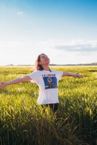 Woman is standing on the green field