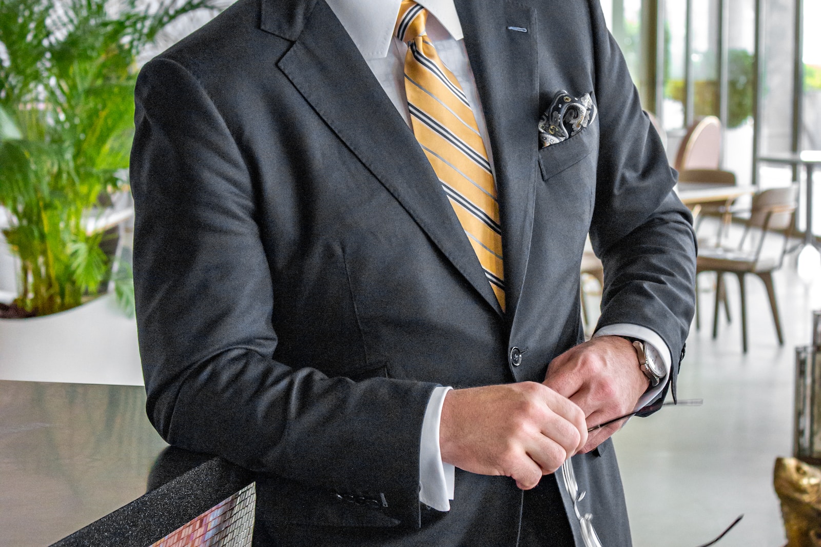 a man in a suit is holding a tie