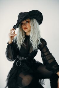 Woman Posing in Black Witch Costume